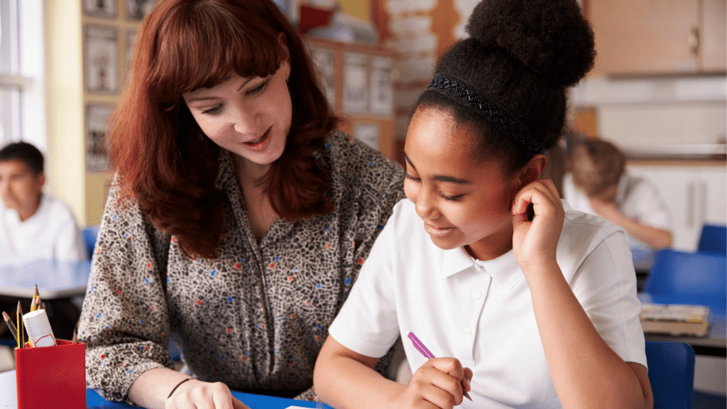 Similar photo of KS2 girl sat with red haired teacher
