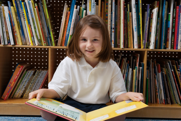 KS1 girl with book