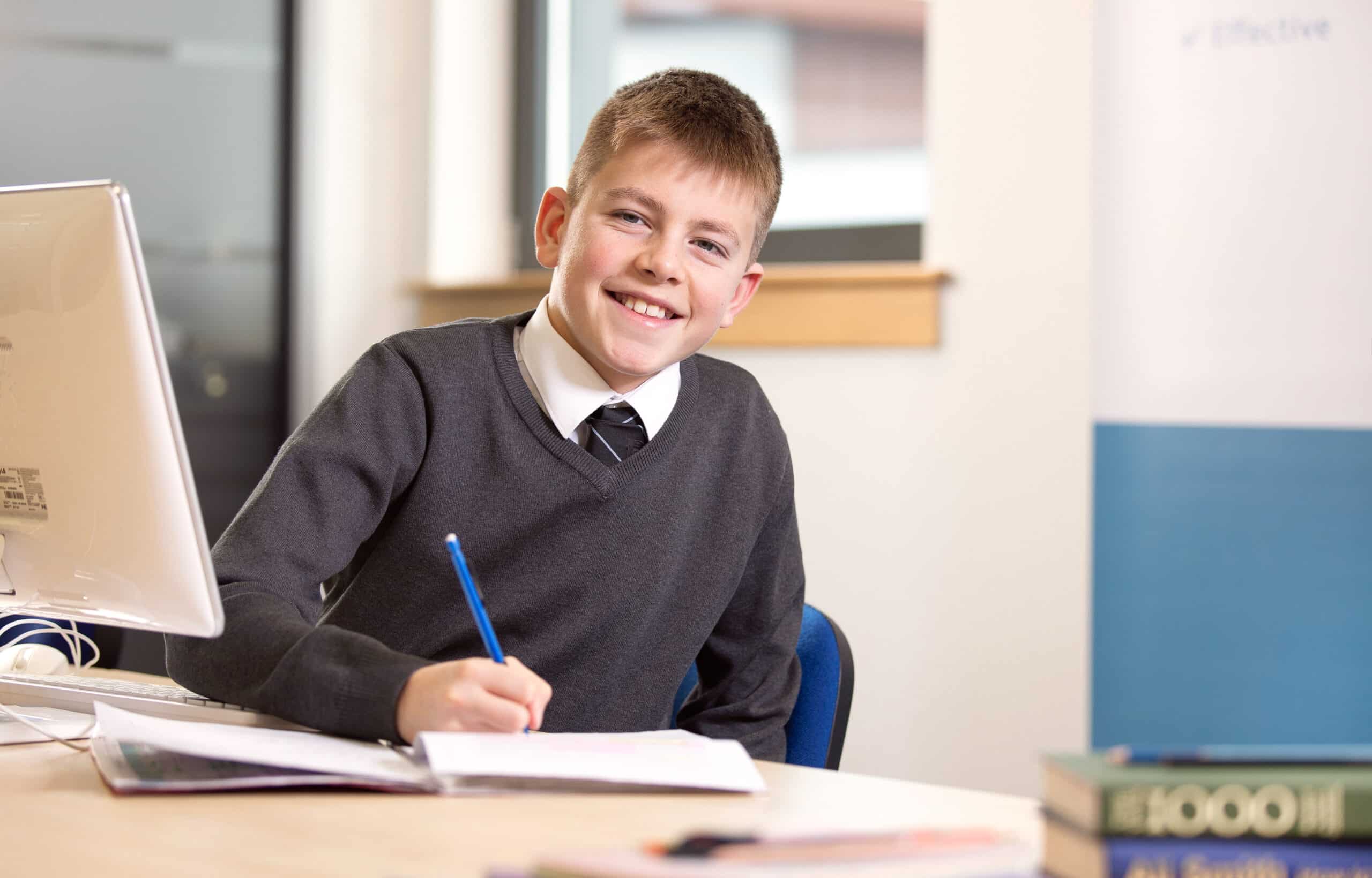 Child sat at desk writing