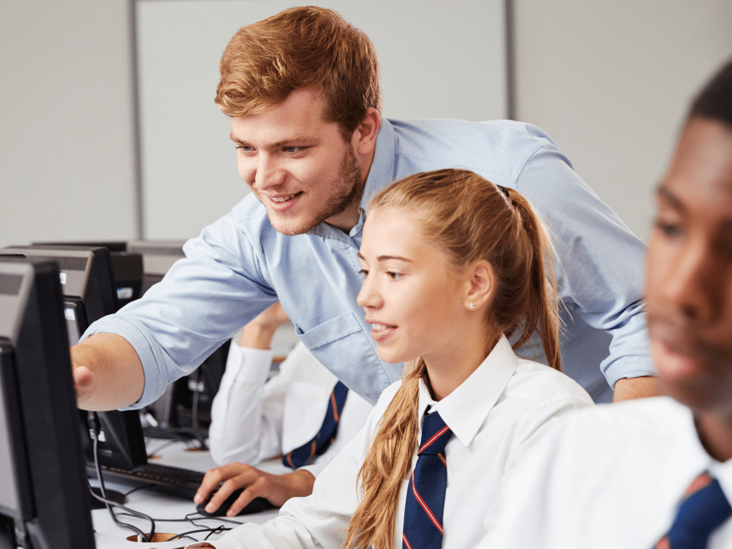Teacher over shoulder of KS3 girl