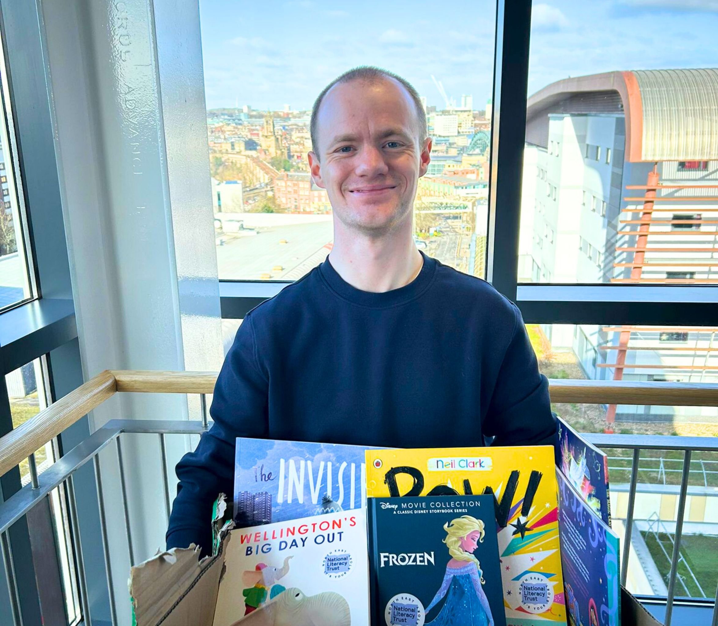 Lee Morrison with some books in a box