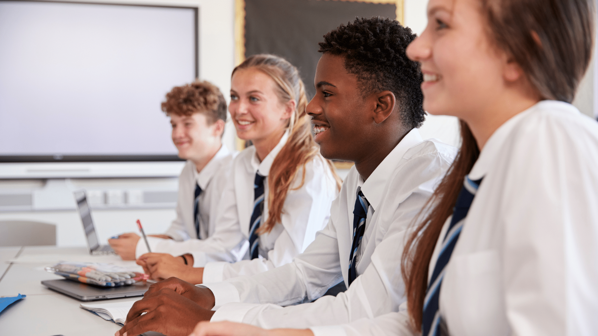 Secondary pupils smiling in classroo
