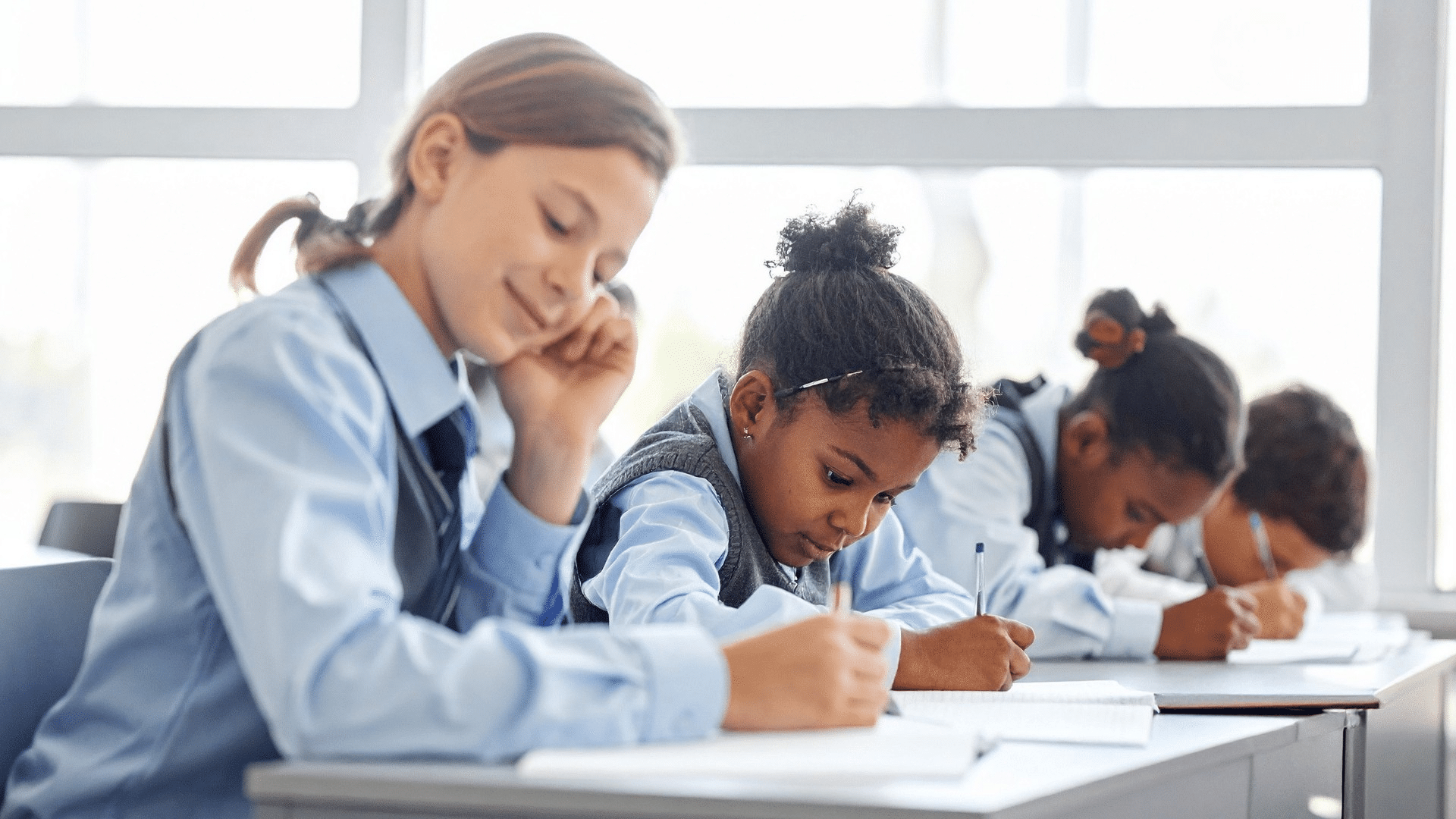 KS3 children writing in line on desks