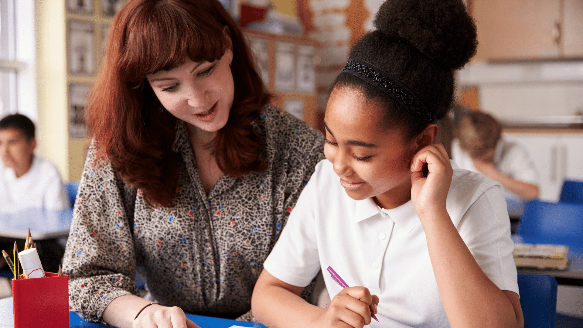Similar photo of KS2 girl sat with red haired teacher